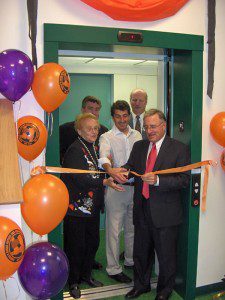 ribbon cutting ceremony on elevator with group of people